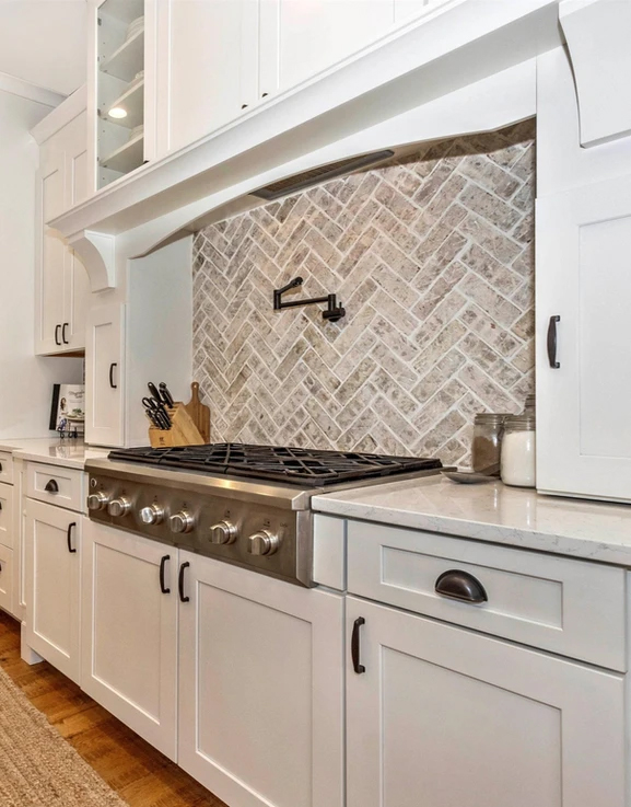 kitchen with white cabinets and silver stove top