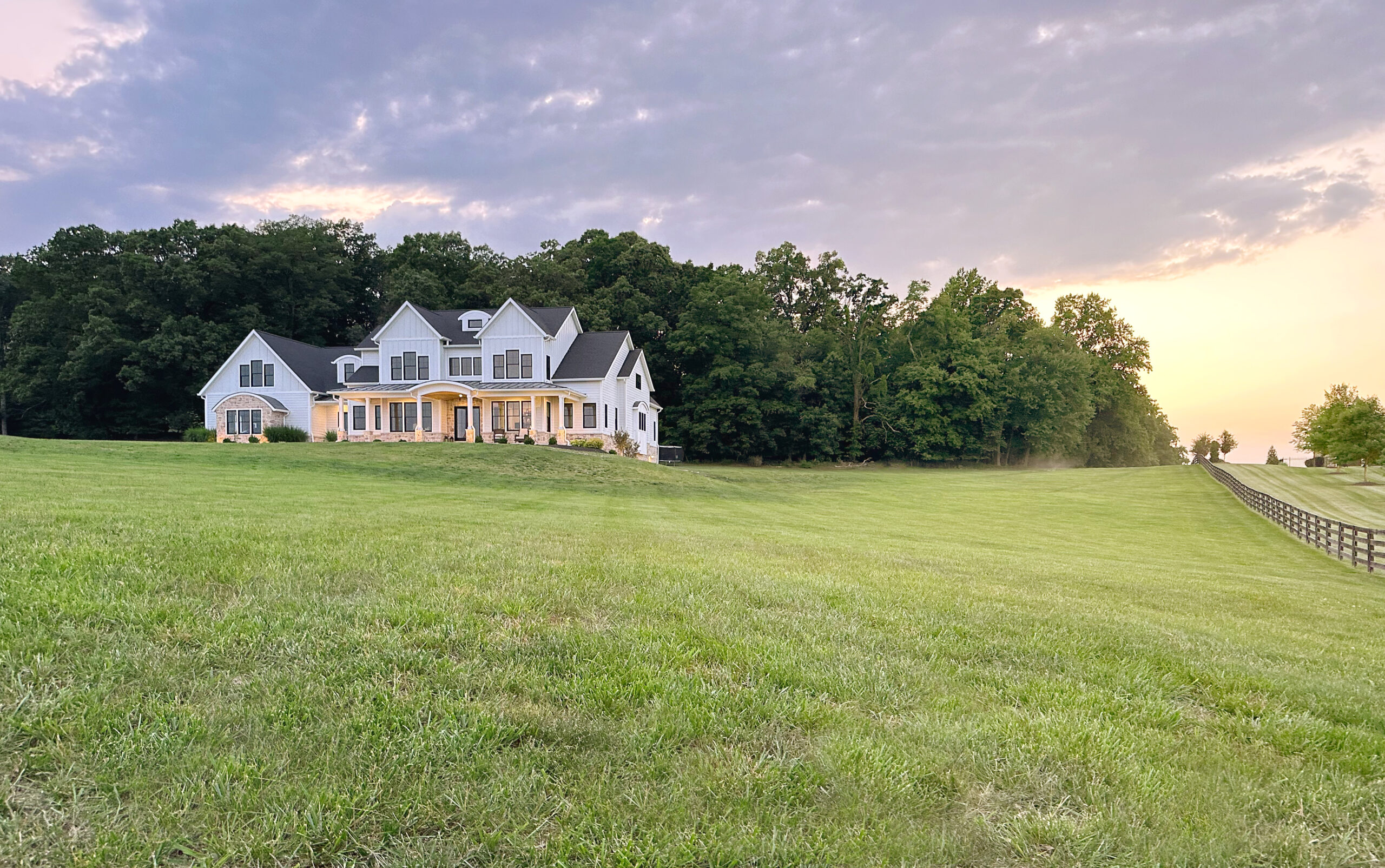large white house with huge property during sunset