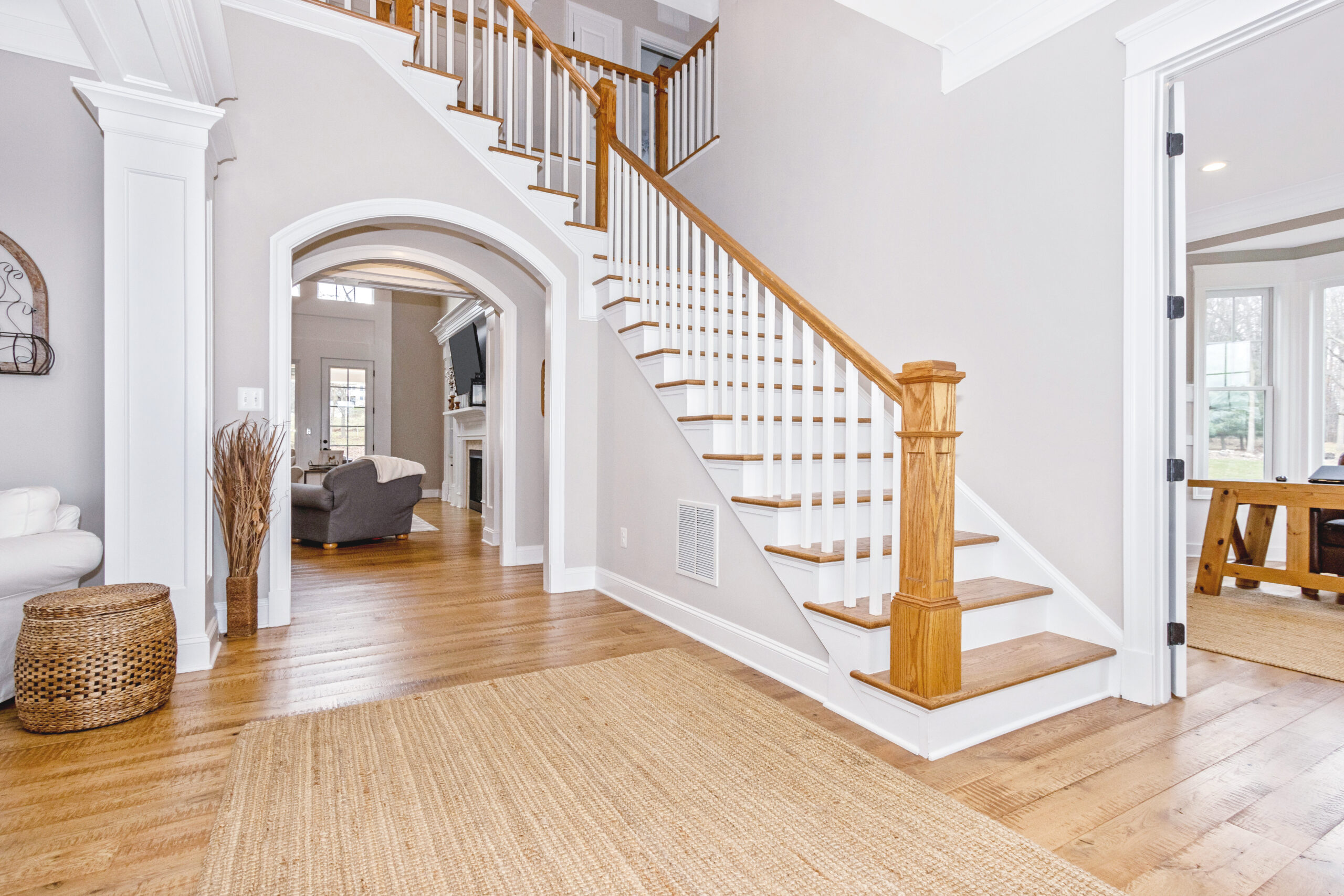 large entryway with a large staircase with wood accents