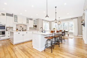 large open-concept kitchen with white cabinetry and large kitchen island