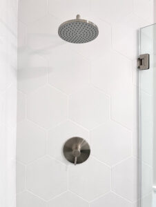 interior of shower with white hexagonal shaped tiles