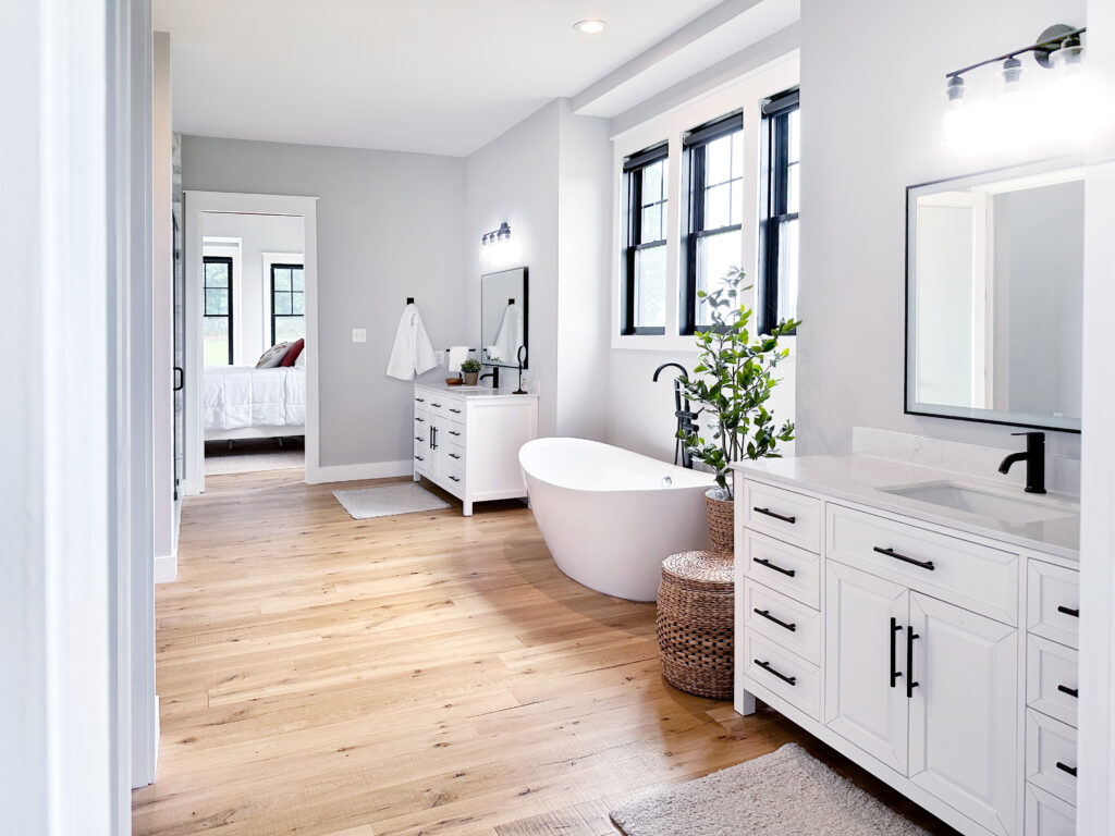 master bathroom with a standalone bathtub and two sinks on either side